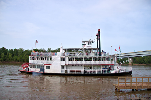 Bossier City, Louisiana, USA - July 16, 2016: The riverboat Memphis Queen III leaving dock on the Red River in Bossier City. According to an official at the dock, this is the first riverboat to come up the Red River since 1920. The Memphis Queen III was in Bossier for a charter cruise.