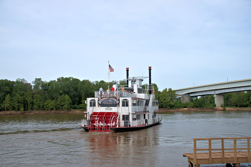 Bossier City, Louisiana, USA - July 16, 2016: The riverboat Memphis Queen III turning after leaving dock on the Red River in Bossier City. According to an official at the dock, this is the first riverboat to come up the Red River since 1920. The Memphis Queen III was in Bossier for a charter cruise.