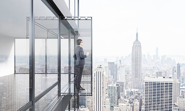 istock Businessman with coffee on balcony 547534508