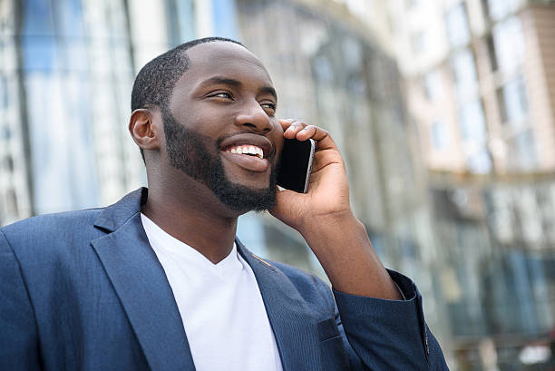 istock Cheerful African businessman using telephone for communication 547534642