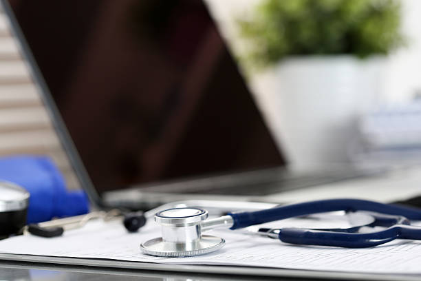 istock Stethoscope head lying on medical form on clipboard pad 547536668