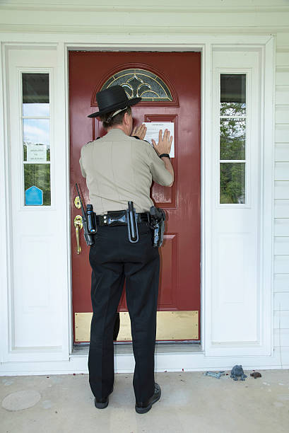 istock Officer placing an eviction notice 547539120