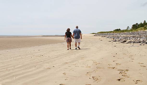 istock mature couple holding hands, back view 547539144
