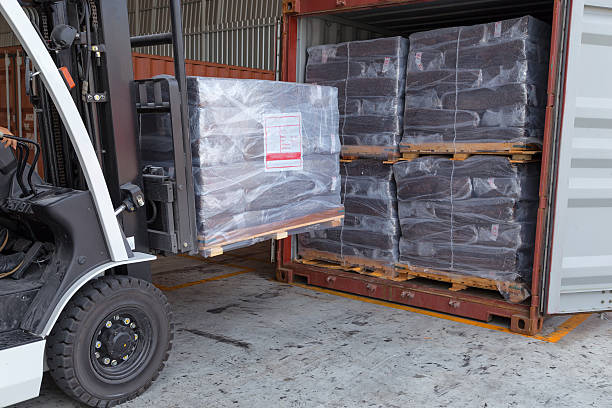 istock Forklift driver stacking of rubber briquette packs 547539326