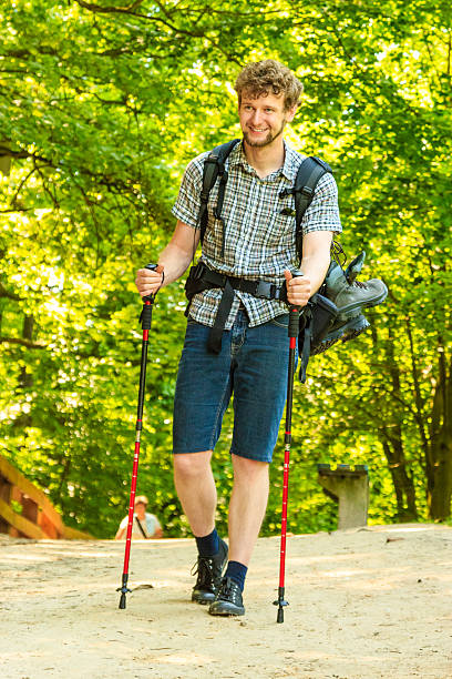 istock young man with backpack hiking in forest trail 547539604