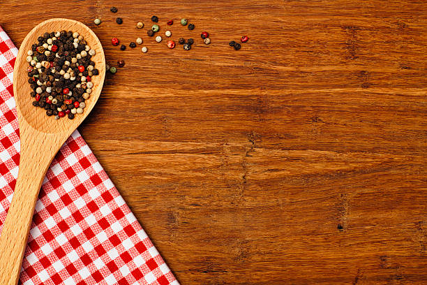 istock Kitchen Wooden Spoon with Pepper Corns on Cutting Board Background 547541000