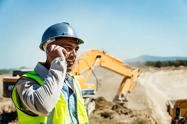 Photo of Architect using mobile phone at quarry