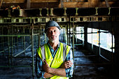 Confident architect standing at construction site