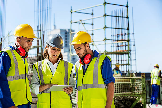 architects using digital tablet at site - byggarbetare bildbanksfoton och bilder