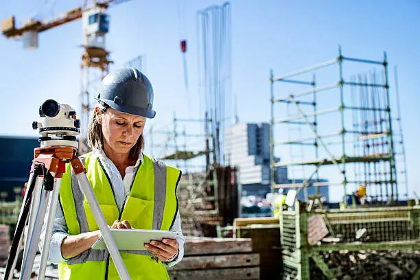 Female architect using digital tablet at construction site