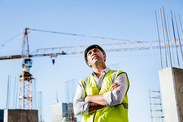 istock Ambitious architect standing arms crossed at site 552721761