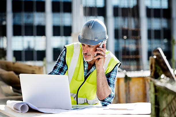 architect working at construction site - computer construction using laptop construction site imagens e fotografias de stock