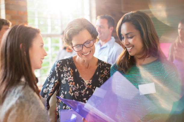 istock Smiling women looking at paperwork in community center 554392229