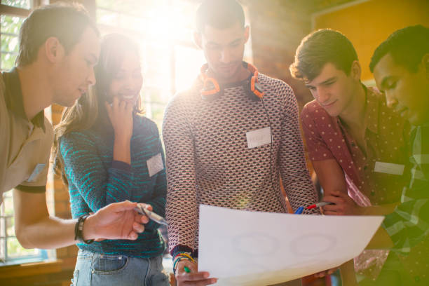 istock Creative business people reviewing proofs in meeting 554392257