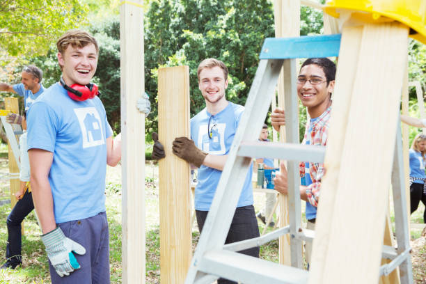 istock Portrait of smiling volunteers working at construction site 554392387