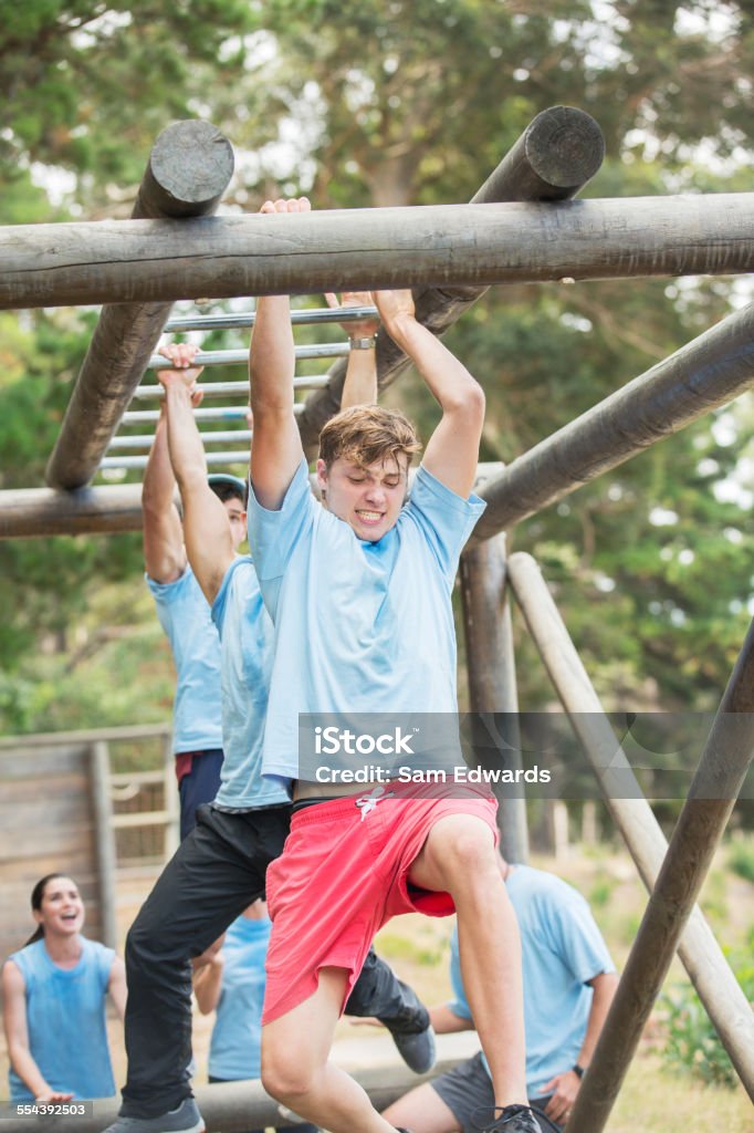Determined Man Crossing Monkey Bars On Boot Camp Obstacle Course Stock  Photo - Download Image Now - iStock