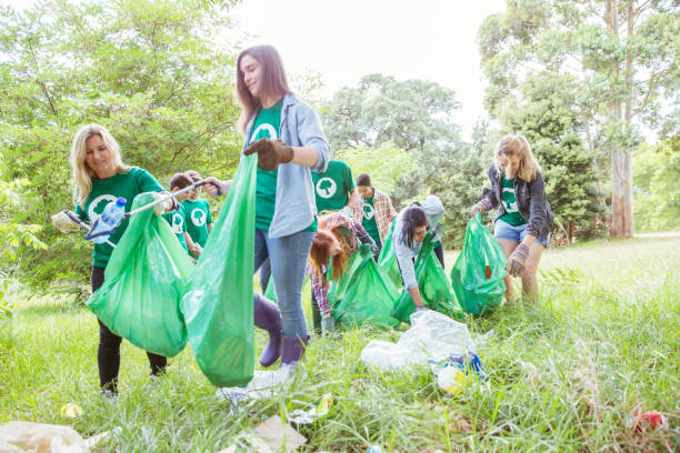 istock Environmentalist volunteers picking up trash in field 554392643