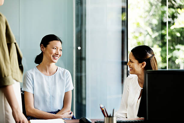 istock Businesswomen discussing in office 555250287