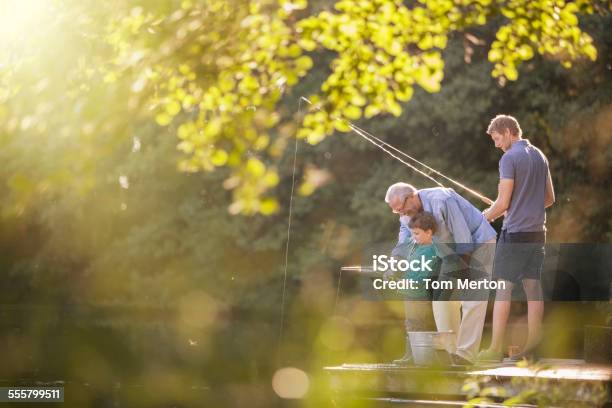 Boy Father And Grandfather Fishing In Lake Stock Photo - Download Image Now - Fishing, Multi-Generation Family, Active Seniors