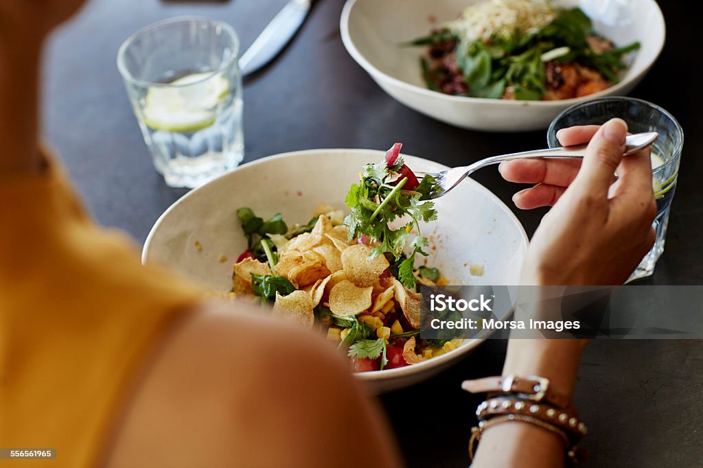 Woman having food at restaurant table - Royalty-free Yemek yemek Stok görsel