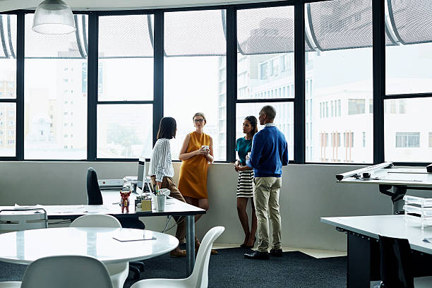 istock Business people having discussion by window 557608451