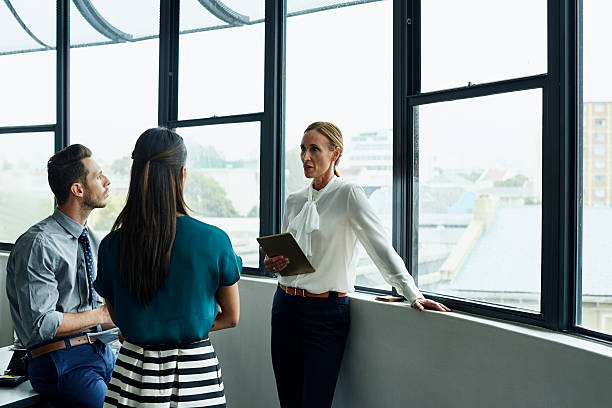istock Businesswoman having discussion with team 557608529