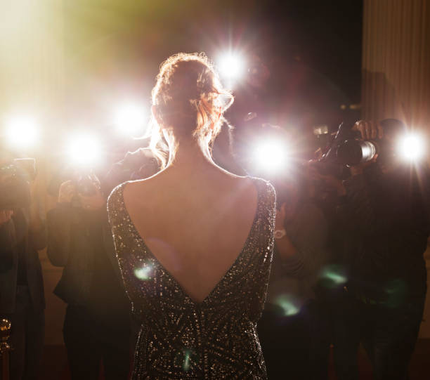 istock Celebrity facing paparazzi photographers at event 559536637