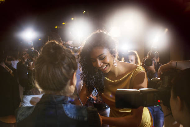 istock Celebrity signing autographs for fans at event 559536739