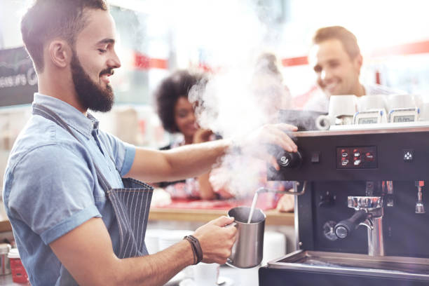 istock Barista steaming milk in cafe 559538221