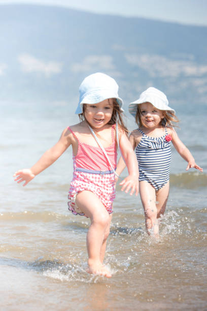 Three Vietnamese little girls walking on the beach, Vietnam