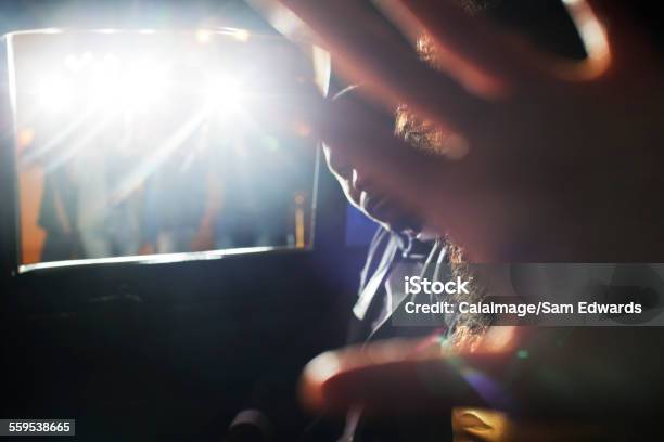 Celebrity Couple Blocking Camera In Limousine At Event Stock Photo - Download Image Now