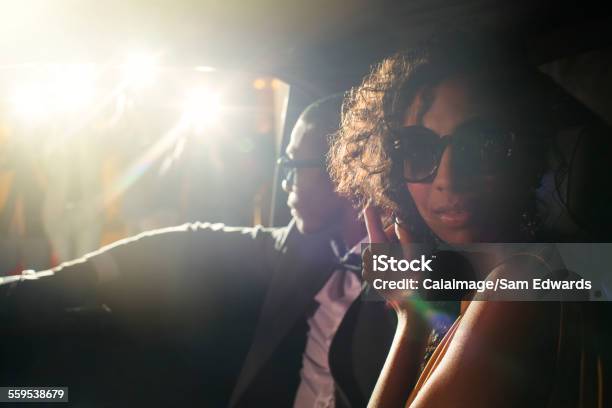 Portrait Of Celebrity Couple In Limousine Arriving At Event Stock Photo - Download Image Now
