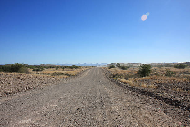 istock Gravel Road Against Clear Blue Sky 559552847