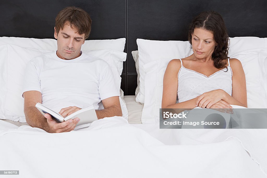 Couple sitting up in bed  30-39 Years Stock Photo