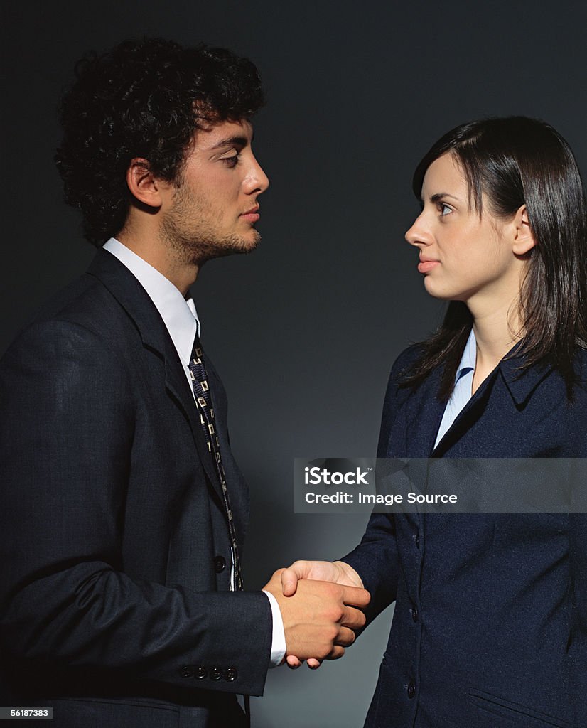 Colleagues shaking hands  Adults Only Stock Photo