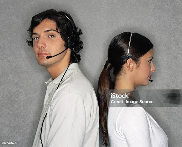 Call Centre Workers Back To Back Stock Photo - Download Image Now - Adults Only, Argentinian Ethnicity, Back To Back