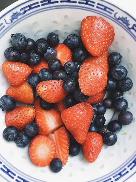 istock Strawberries And Blueberries In Bowl 562416643