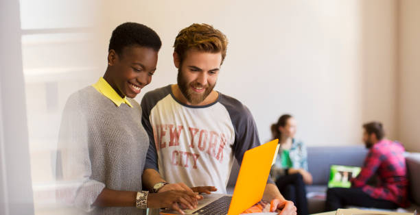 istock Casual business people sharing laptop in office 562873175