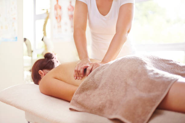 istock Woman receiving massage by masseuse 562873239