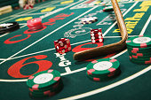 istock Croupier stick clearing craps table 56294135