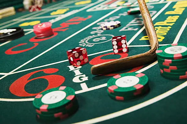 Photo of Croupier stick clearing craps table