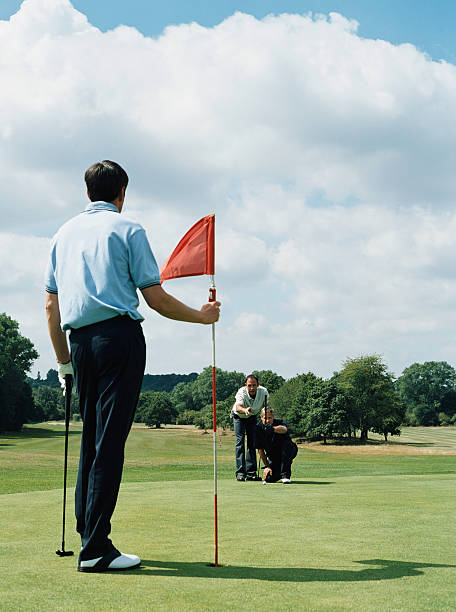 men playing golf - caddy fotografías e imágenes de stock