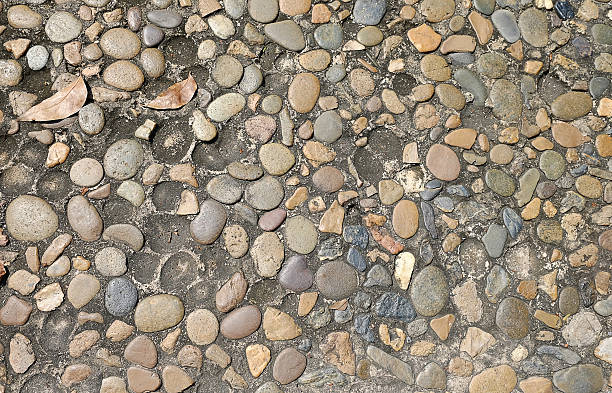 istock Decorative floor pattern of gravel stones texture background 564560278