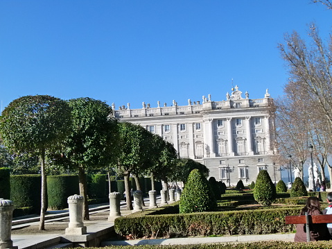Madrid, Spain - January 2, 2011: The Royal Palace Palacio Real in Madrid, Spain. Photo taken during the day from the square in front, and contains tourists and locals walking about.