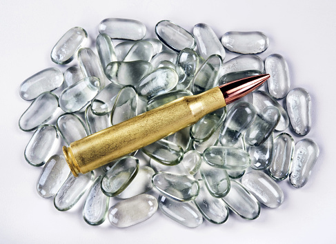 50 caliber brass bullet on polished glass stones.