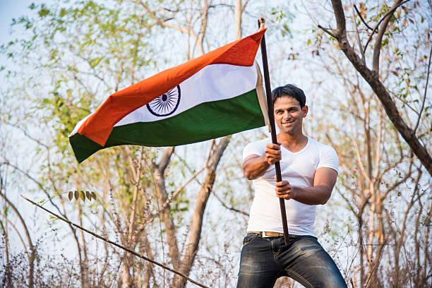 istock indian young man waving indian flag 564561436