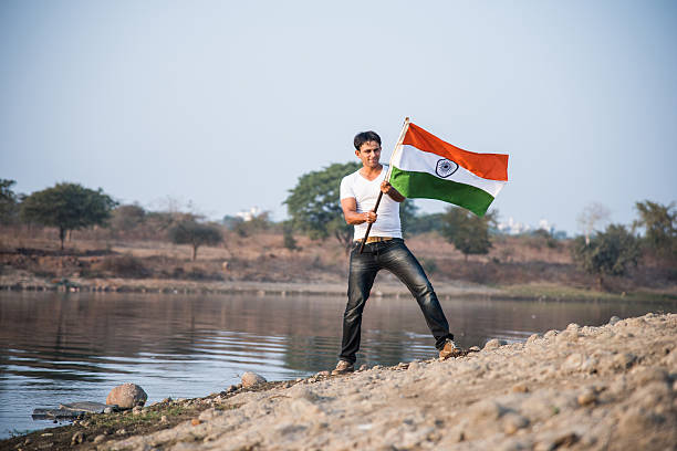 istock indian young man waving indian flag 564561852