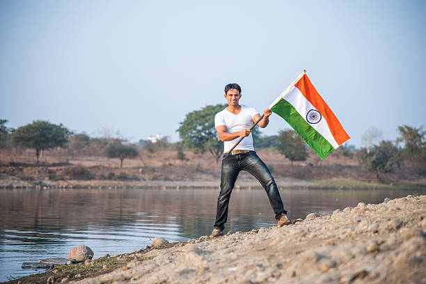 istock indian young man waving indian flag 564562064