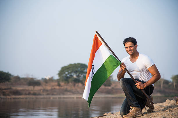 istock indian young man waving indian flag 564562188