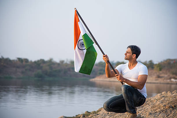 istock indian young man waving indian flag 564562558